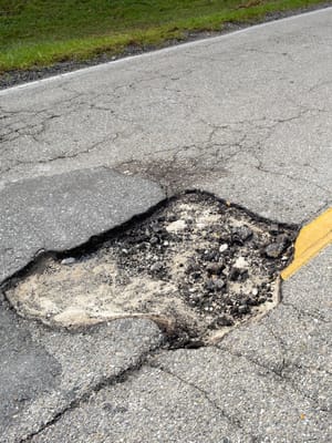 a pothole in the road demonstrating the worst highways for RVs